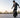 Beginner rider practicing balance on a Kingsong electric unicycle in an open training area