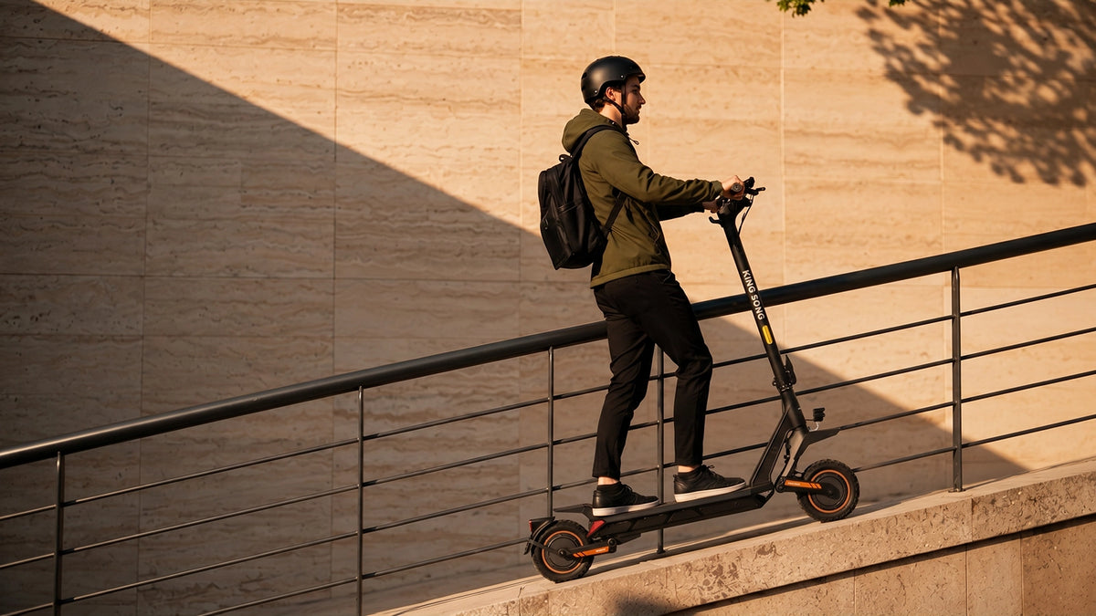 Rider on a Kingsong N12T3 electric scooter on an urban incline
